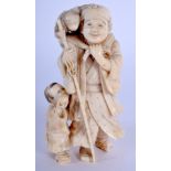 A 19TH CENTURY JAPANESE MEIJI PERIOD CARVED IVORY OKIMONO modelled as a male beside a monkey and boy