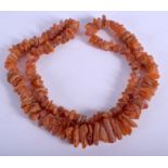 A VINTAGE CRUSHED AMBER NECKLACE. 80 cm long.