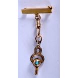 AN ANTIQUE YELLOW METAL AND TURQUOISE FOB. 6.1 grams.