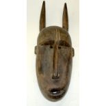 A TRIBAL BAMANA NTOMO MASK. Mali. 19cm x18cm x 56cm