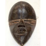 A TRIBAL TANGAGLE DAN MASK. Ivory Coast. 16cm x 9cm x 25cm