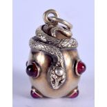 A CONTINENTAL SILVER GILT SERPENT RUBY PENDANT. 2.5 cm x 1.5 cm.