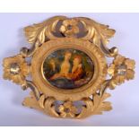 AN 18TH CENTURY CONTINENTAL GILTWOOD FRAME containing a period painted ivory painting of lovers. 21