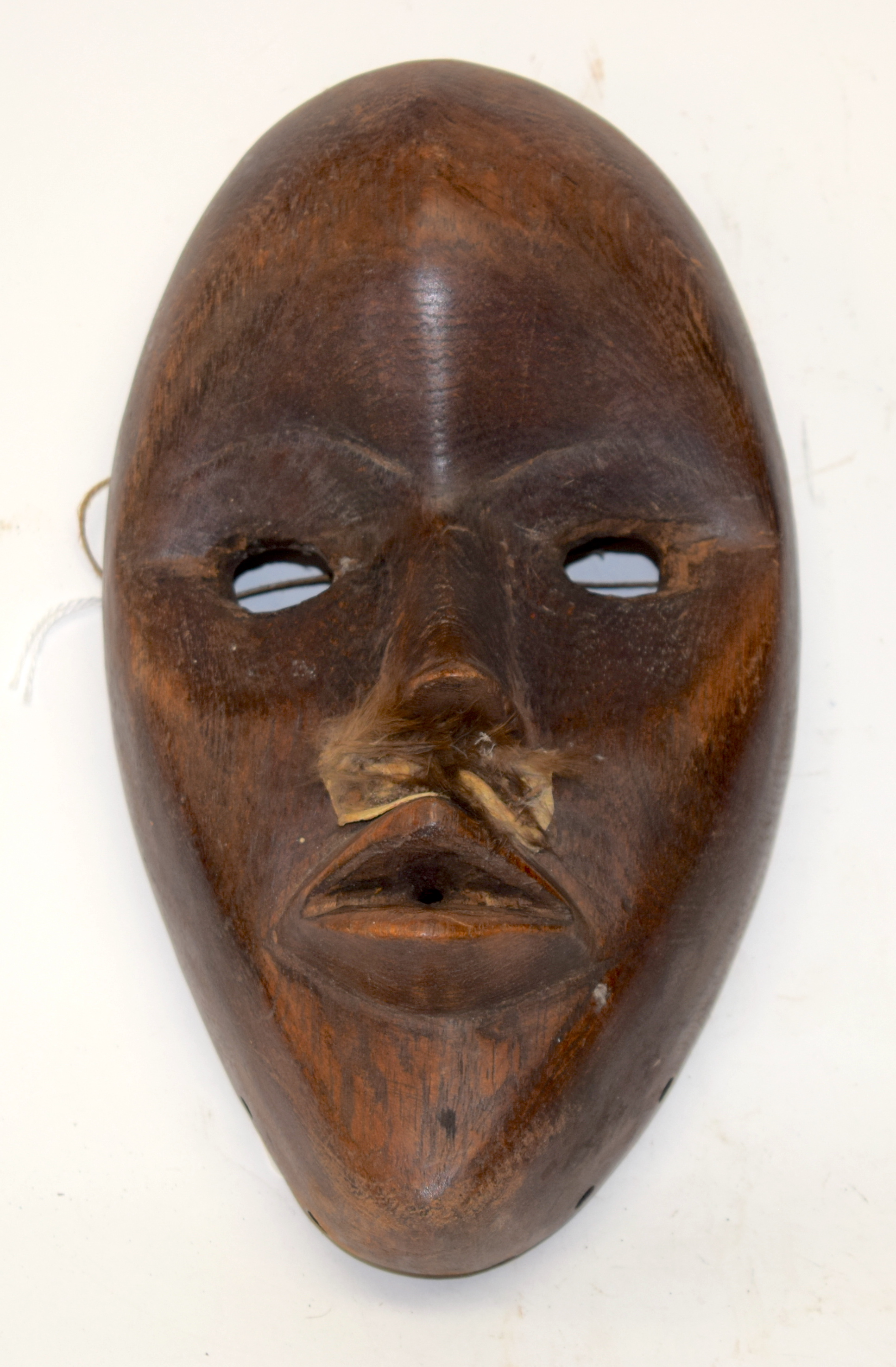 A TRIBAL DAN MASK. Ivory Coast. 13cm x 4cm x 22cm