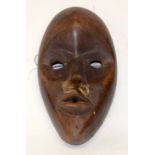 A TRIBAL DAN MASK. Ivory Coast. 13cm x 4cm x 22cm