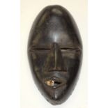 A TRIBAL DAN MASK. Ivory Coast. 12cm x 6cm x 21cm