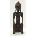 A TRIBAL BAMANA SEATED FIGURE, JONYELENI. Mali. 10cm x 11cm x 34cm