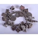 A VINTAGE SILVER CHARM BRACELET. 85.4 grams.