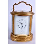 A FINE ANTIQUE REPEATING OVAL CARRIAGE CLOCK decorated with motifs. 18 cm high inc handle.