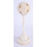 A 19TH CENTURY CHINESE CARVED IVORY PUZZLE BALL ON STAND Qing. 25 cm high, ball 7.5 cm wide.