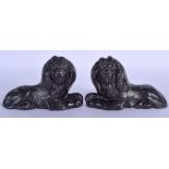 A PAIR OF GEORGE III CAST IRON LIONS modelled recumbant. 15 cm wide.