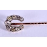 A VICTORIAN YELLOW GOLD AND DIAMOND HORSE SHOE TIE PIN. 1.9 grams. 5.5 cm long.