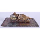 A CONTINENTAL COLD PAINTED BRONZE EROTIC LADY modelled reclining. 15 cm x 10 cm.