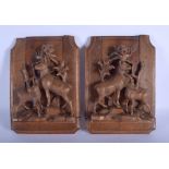 A PAIR OF 19TH CENTURY BAVARIAN BLACK FOREST BOOK ENDS formed with stags within landscapes. Each 40