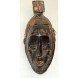 A TRIBAL BAULE GURO MASK. Ivory Coast. 14cm x 11cm x 36cm