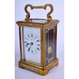 AN ANTIQUE BRASS REPEATING CARRIAGE CLOCK. 15 cm high inc handle.