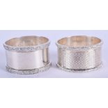 A PAIR OF MODERN SILVER NAPKIN RINGS. 2.2 oz. 4.75 cm wide.