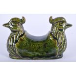 A CHINESE MARBLED POTTERY FIGURE OF A BRUSH REST formed with opposing birds. 11 cm x 8 cm.