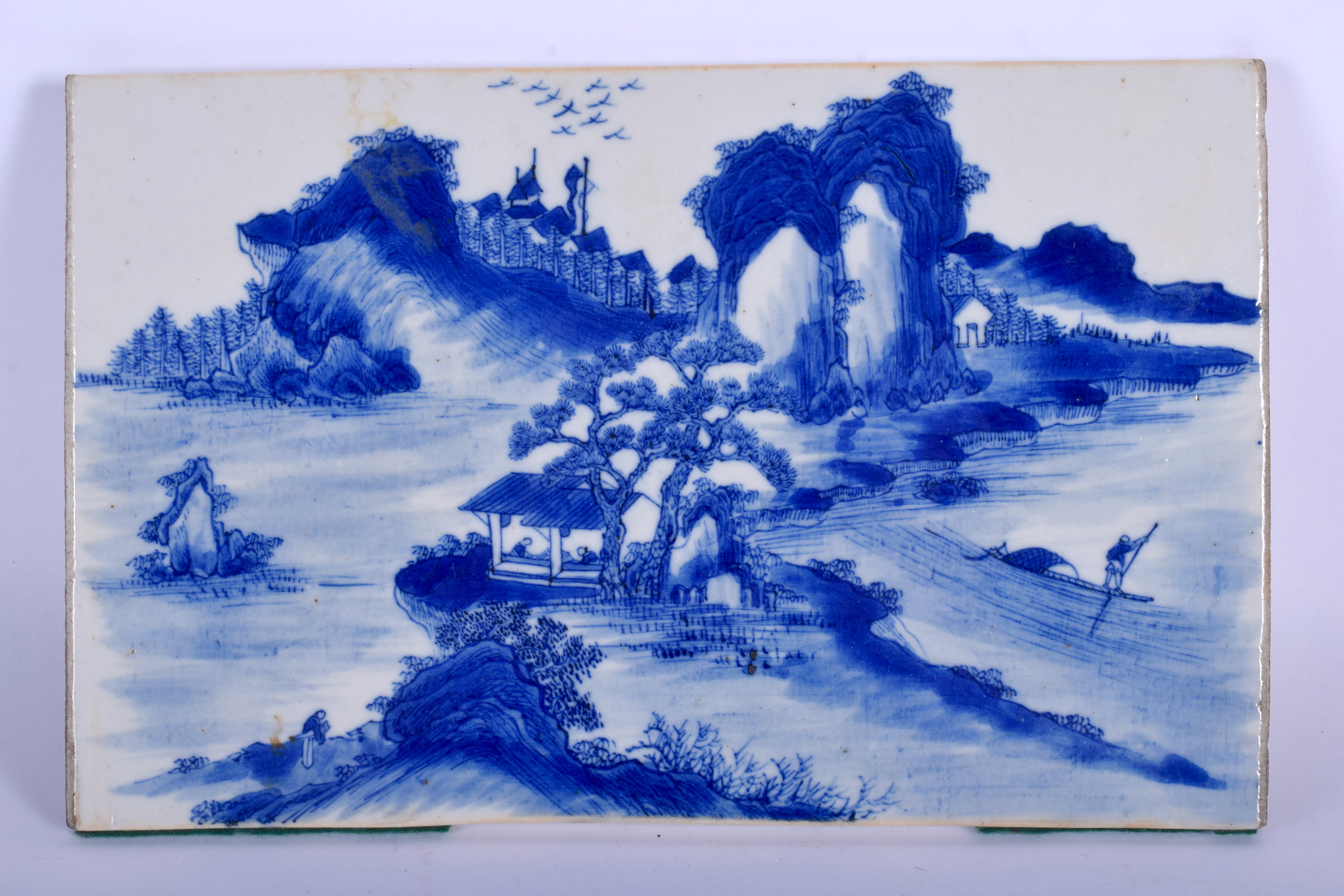 A 19TH CENTURY CHINESE BLUE AND WHITE RECTANGULAR BLUE AND WHITE TILE Qing. 25 cm x 15 cm.