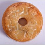 A CHINESE CARVED MUTTON JADE ROUNDEL. 5.5 cm diameter.