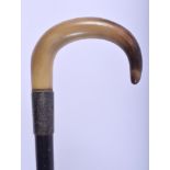 A 19TH CENTURY CONTINENTAL CARVED BUFFALO HORN HANDLED WALKING CANE. 88 cm long.