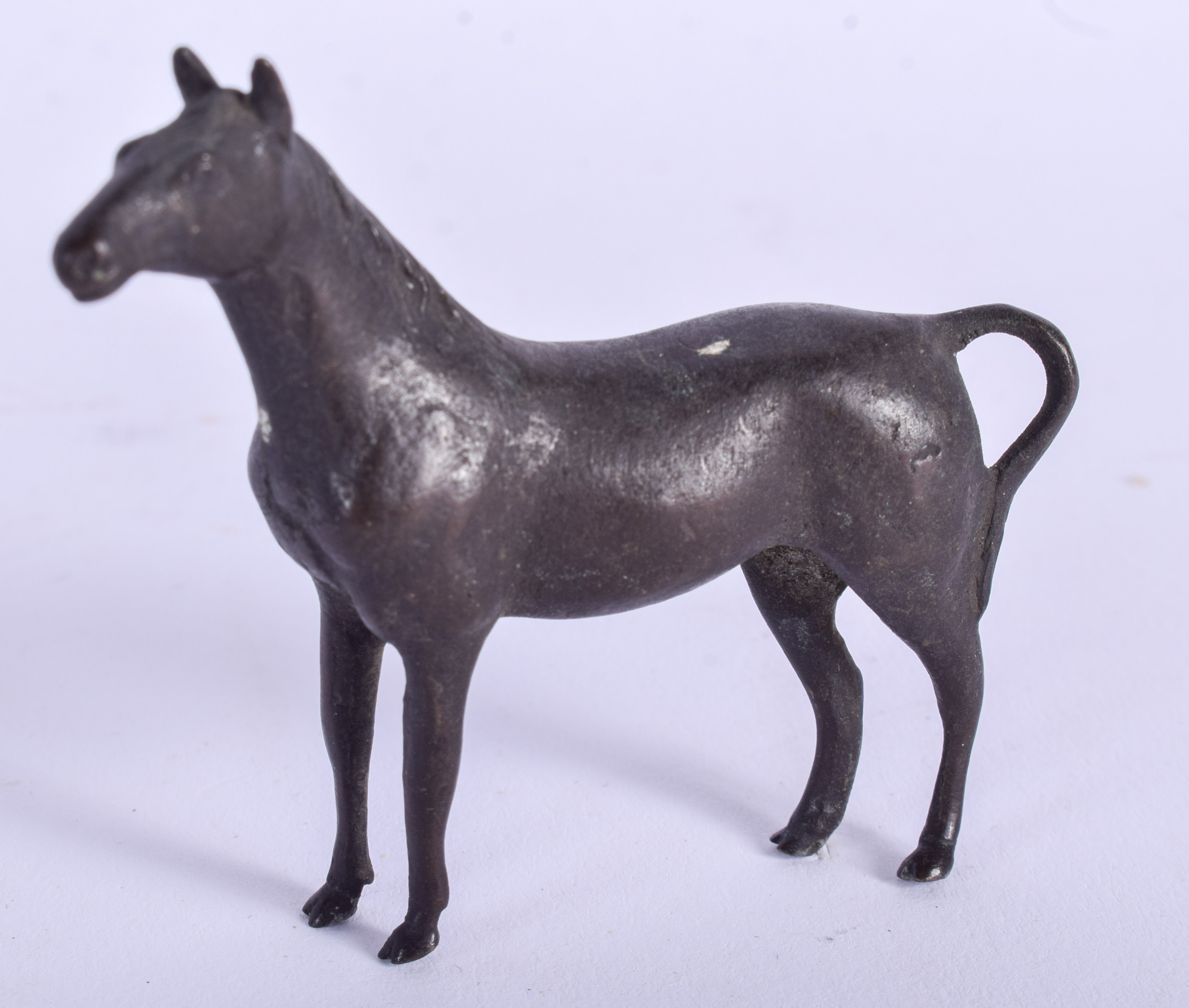 A CONTINENTAL BRONZE HORSE. 7 cm x 5 cm.