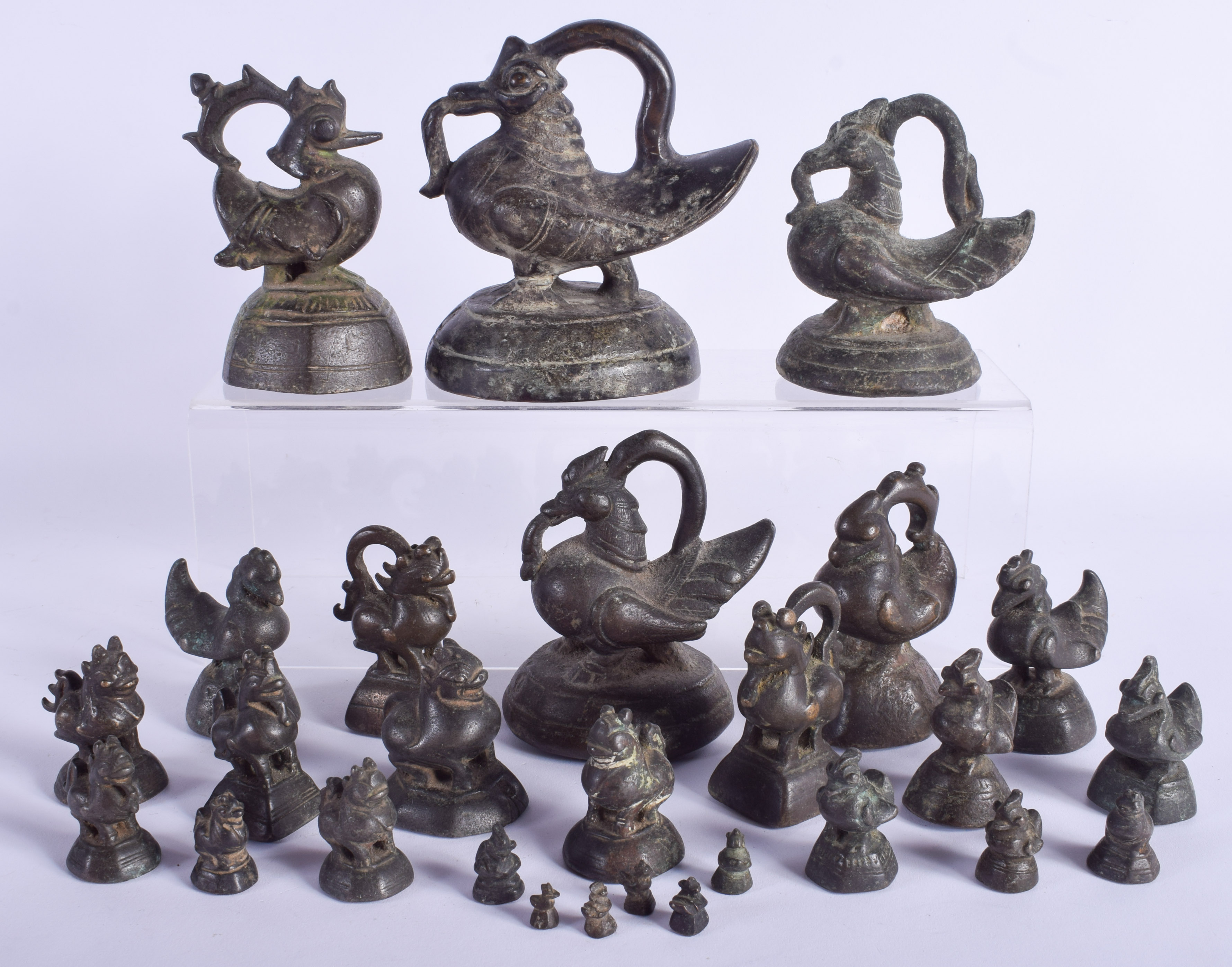 A RARE SET OF 19TH CENTURY INDIAN GRADUATED BRONZE WEIGHTS in the form of birds. Largest 15 cm x 11