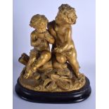 A 19TH CENTURY FRENCH GILDED SPELTER FIGURE OF TWO PUTTI modelled upon am eboinsed base. 21 cm x 27
