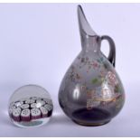 AN AESTHETIC MOVEMENT GLASS JUG enamelled with foliage, together with a paperweight. Jug 24 cm high,