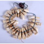 A VINTAGE TRIBAL TOOTH NECKLACE. 34 cm long.