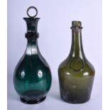 AN ANTIQUE GREEN GLASS DECANTER AND STOPPER together with a benedictine bottle. Largest 31 cm high.