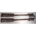 A PAIR OF VINTAGE TRIBAL NORTH JAVA BORNEO DAYAK PADDLES with carved figural motifs and animal termi