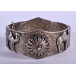 A VINTAGE INDIAN WHITE METAL BANGLE decorated with camels. 51 grams. 6.5 cm wide.