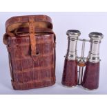 A PAIR OF EARLY 20TH CENTURY LEATHER AND CHROME BINOCULARS within a case. 18 cm x 12 cm extended.