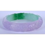 A CHINESE CARVED TWO TONE JADE BANGLE. 7.25 cm wide.