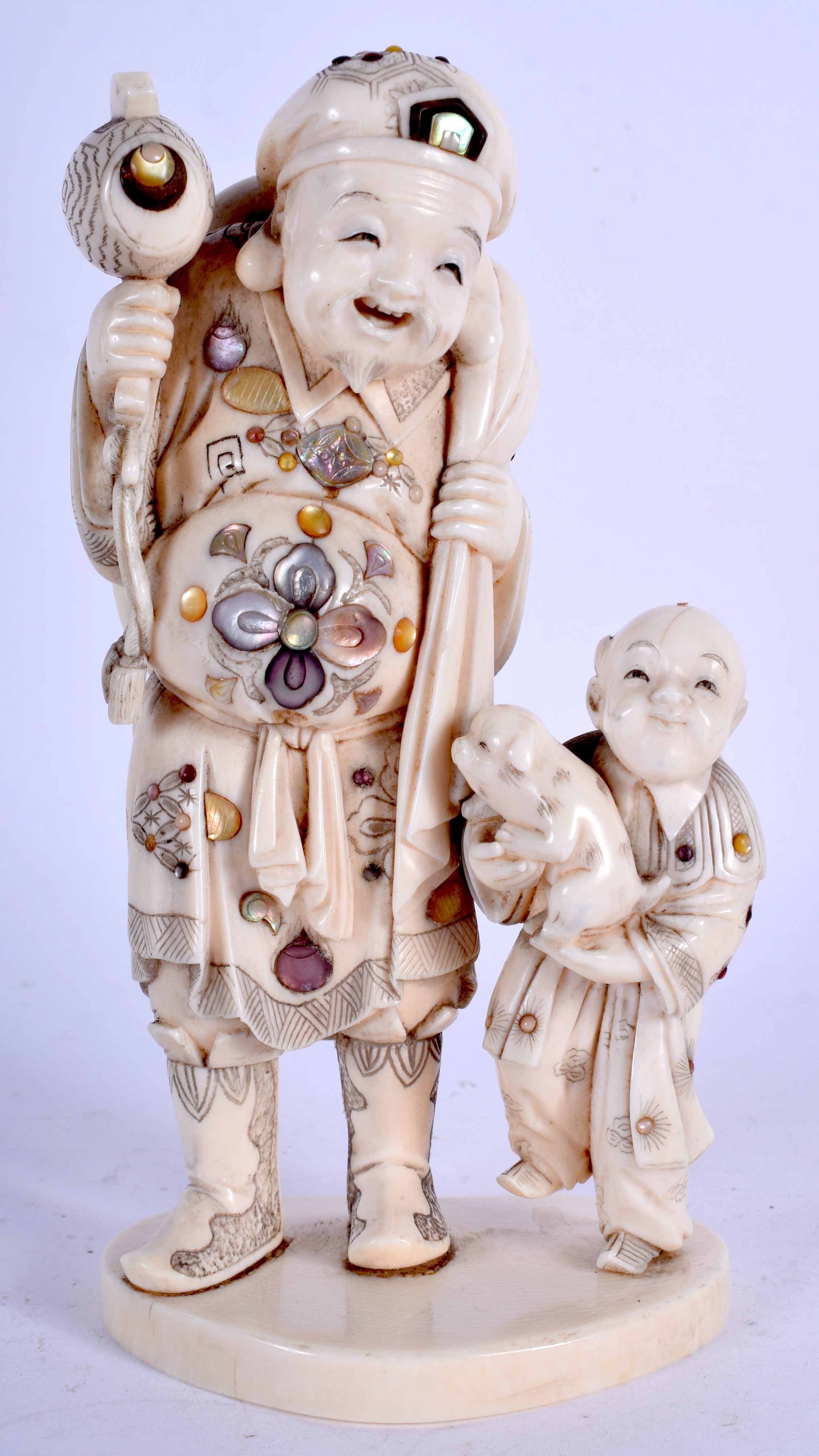 A 19TH CENTURY JAPANESE MEIJI PERIOD SHIBAYAMA INLAID IVORY FIGURE embellished in flowers. 15 cm x 6