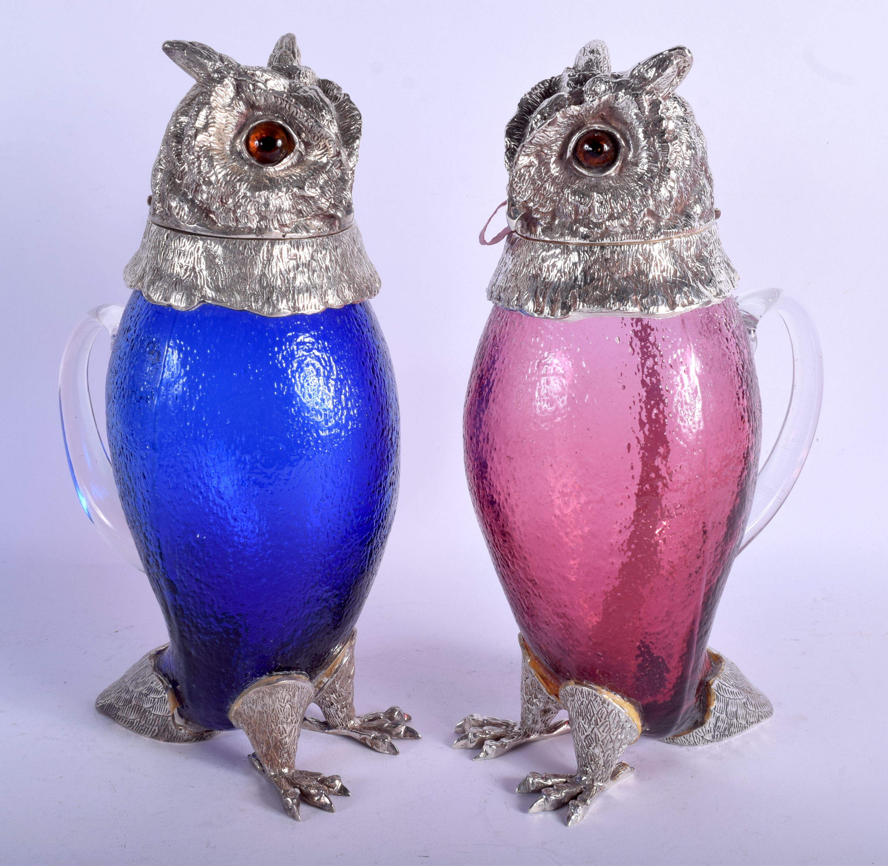 A PAIR OF CONTEMPORARY SILVER PLATED OWL DECANTERS. 31 cm high.
