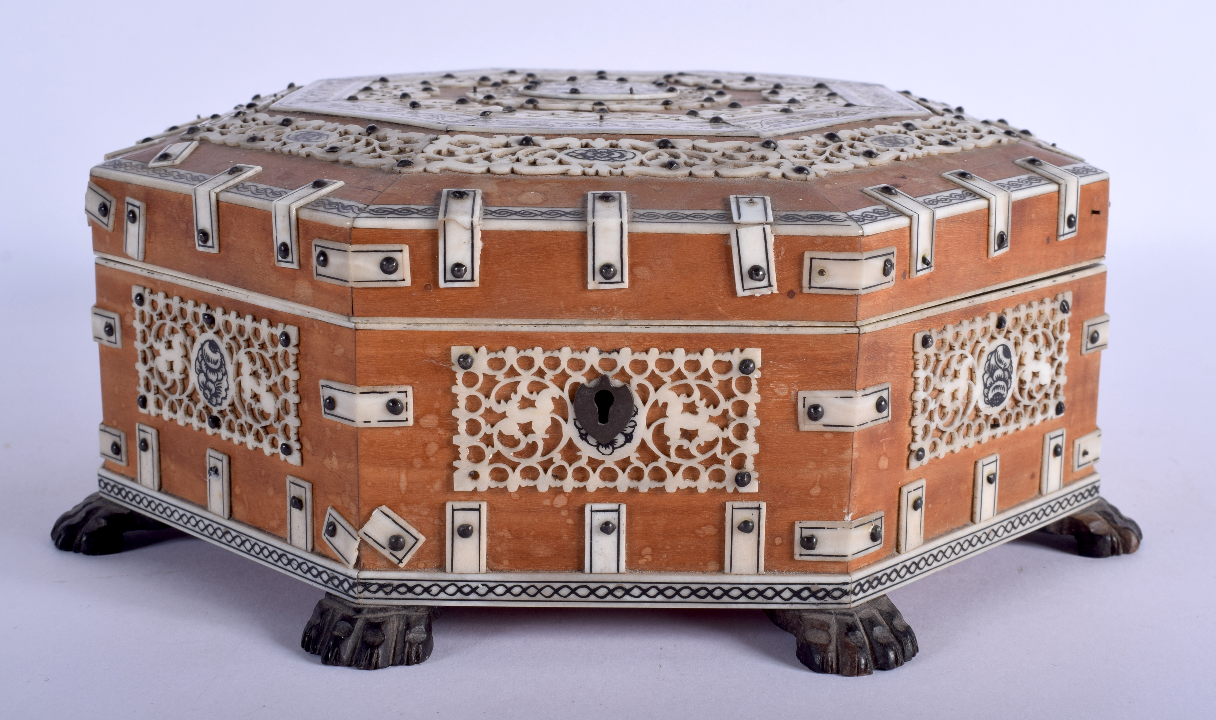 A MID 19TH CENTURY ANGLO INDIAN CARVED IVORY AND SANDALWOOD OCTAGONAL BOX decorated with flowers and