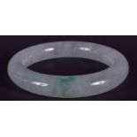 AN EARLY 20TH CENTURY CHINESE CARVED JADEITE BANGLE Late Qing. 8 cm wide.