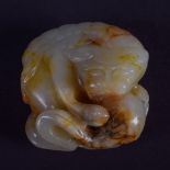 AN 18TH/19TH CENTURY CHINESE CARVED GREENISH MUTTON JADE FIGURE Qing, modelled clutching a ball. 3.5