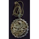 AN EARLY 20TH CENTURY CHINESE CARVED GREEN JADE PENDANT Late Qing/Republic. 5 cm wide.