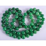 A STRING OF JADE BEADS. 80 cm long.