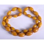 AN AMBER TYPE NECKLACE. 48 grams. 54 cm long, largest bead 2.5 cm wide.