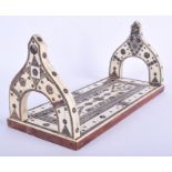 A RARE 19TH CENTURY ANGLO IDIAN CARVED IVORY MICRO MOSAIC SLIDING BOOK RACK decorated with foliage.