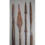 FOUR EARLY 20TH CENTURY TRIBAL SPEARS with metal mounts. Largest 158 cm long. (4)