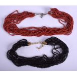TWO CONTINENTAL CORAL NECKLACES. (2)
