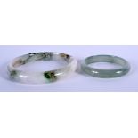 TWO CHINESE JADE BANGLES. Largest 8 cm wide. (2)