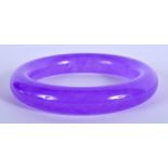 A CHINESE PURPLE JADE BANGLE. 7.5 cm wide.