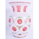 A VINTAGE BOHEMIAN WHITE OVERLAID ENAMELLED VASE painted with flowers. 21 cm x 11 cm.