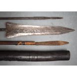 THREE VINTAGE TRIBAL SPEARS together with a long pipe. Largest 220 cm long. (4)